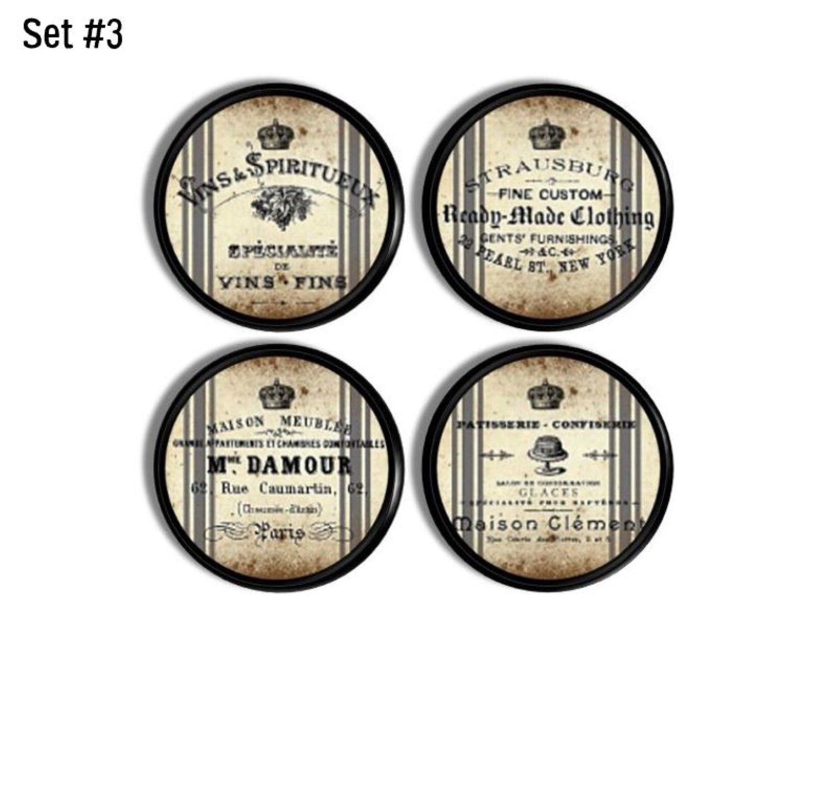 Set of 4 decorative cabinet door and drawer pull hardware in a French shop theme. Vintage clothing and bakery store signs on gray striped old flour bag.