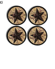 Set of four cabinet knobs featuring black five-point stars with red berry branches on aged parchment backgrounds.