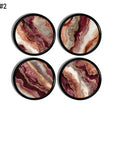 Burgundy and rose agate‑print cabinet knobs with warm mineral banding, shown as a coordinated 4‑piece set