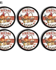 Distressed vintage country cupboard drawer pulls in a chicken theme with the words Farm Fresh Eggs. Colors are red and white on a black handle.