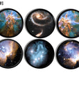 Six black knobs featuring vivid galaxy and nebula artwork. Includes spiral galaxies, star clusters, and colorful cosmic clouds. Handcrafted drawer pulls for celestial bedroom or space themed décor.