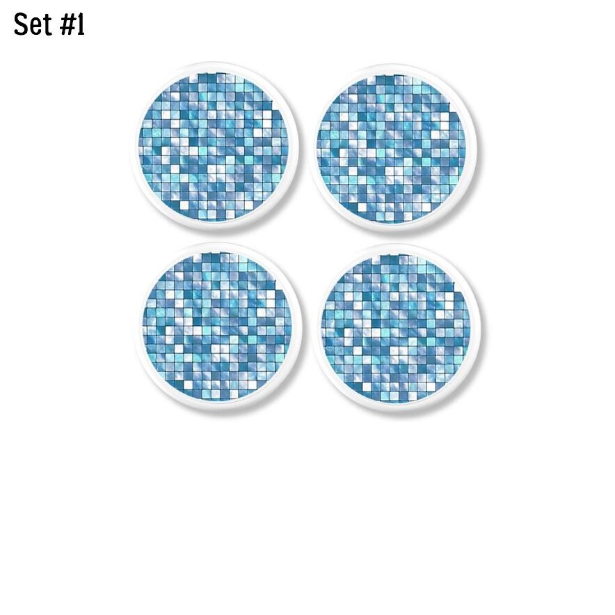 Sky blue mosaic tile-look cabinet knobs displayed on white wood bases; handmade drawer pulls with high-gloss finish.