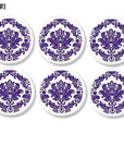 Set of 6 chic furniture knobs decorated with an ornate damask in deep purple on a white background. Cabinet drawer pulls for a feminine regal bathroom.
