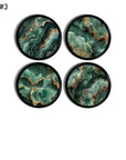 Set of four emerald and gold geode‑inspired cabinet knobs. Decorative hardware featuring swirling mineral art for art deco and retro glam décor.