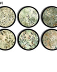 Watercolor leaf cabinet knobs and drawer pull handles with soft sage and beige foliage on a bold black wood base