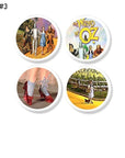 Set of 4 Wizard of Oz cabinet knobs with ruby slippers, Toto, Yellow Brick Road, and vintage title art on white drawer pull base