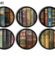 A set of vintage style cabinet knobs or drawer pulls, featuring an illustration of old, bound books in a circular black frame design.