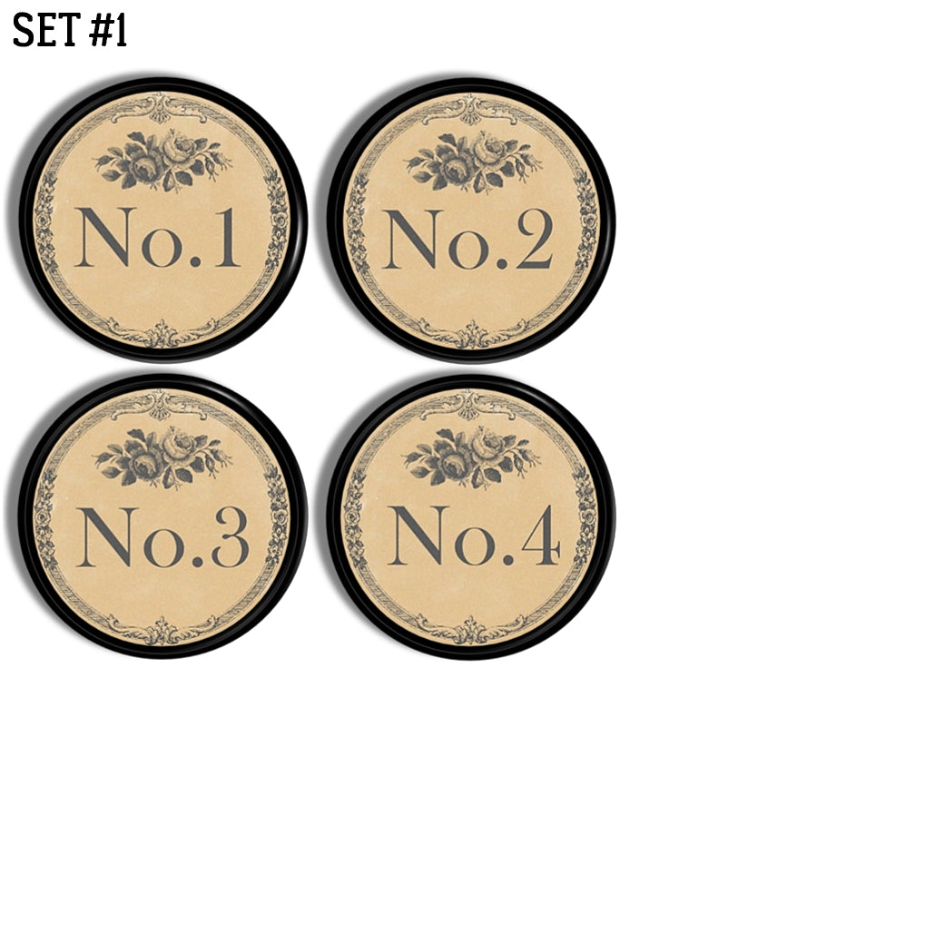 Four handmade cabinet knobs decorated in numbers 1 through 4. The design is inspired by vintage French hotel door plate with an antique font and subtle gray floral accents on an antique beige background.
