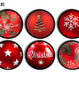Six‑piece Christmas ornament cabinet knob set in red with mixed holiday designs including poinsettias, snowflakes, stars, pine branches, gold tree art, and “Christmas” script for festive seasonal décor hardware