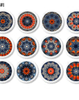 Twelve handcrafted cabinet knobs featuring intricate mandala designs inspired by starburst quilts — each with a unique kaleidoscope pattern in vibrant blue, red-orange, and beige tones. Ideal for expressive drawer pulls in Boho, Cottagecore, or eclectic home décor.