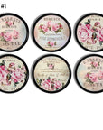 6 piece cabinet knob set featuring French perfume label art — pale pink roses and Paris typography on chic black knobs.