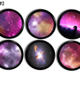 6 drawer pulls decorated with galaxies of outer space star clusters in bright pink, black with blue and gold. Boho wanderlust astrology