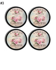 Victorian French boutique style handmade cabinet knobs — weathered pink rose florals with ornate Paris lettering on glossy black knobs.