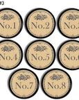 Set of 8 decorative furniture knob hardware. Each round drawer pull is numbered with one number in a series of 1-8 and accented with subtle gray florals. Style is a rustic French inspired to coordinate with vintage industrial, French country or antique farmhouse décor.