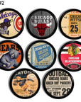 Black cabinet knobs with retro Chicago sports collectibles. Features historic ticket stubs, logos, and event graphics from Cubs, Bears, Bulls, Blackhawks, and Golden Gloves boxing. Man cave accent hardware set of 8.