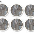 Handmade cabinet knob set featuring distressed weathered wood graphics in soft gray and faded blue tones.