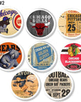 Eight handcrafted cabinet knobs with white bases featuring vintage Chicago sports ticket stubs, logos, and memorabilia. Includes Cubs, Bears, Bulls, Blackhawks, and boxing designs. Retro fan cave hardware set of 8.
