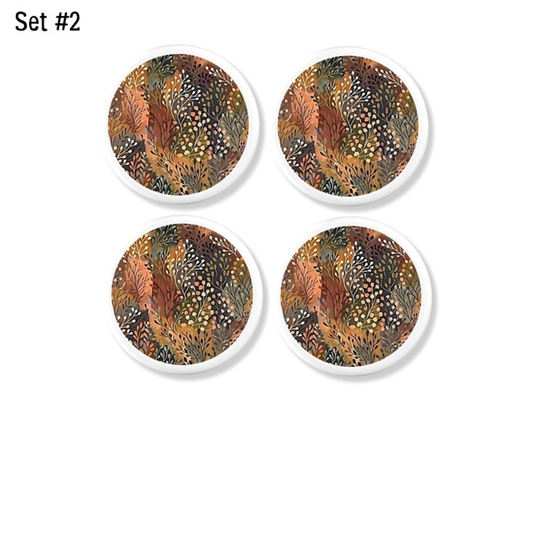 Earth‑tone botanical cabinet knobs. Decorative hardware featuring layered autumn foliage and abstract leaf forms with warm seasonal accents for organic modern and rustic‑refined décor