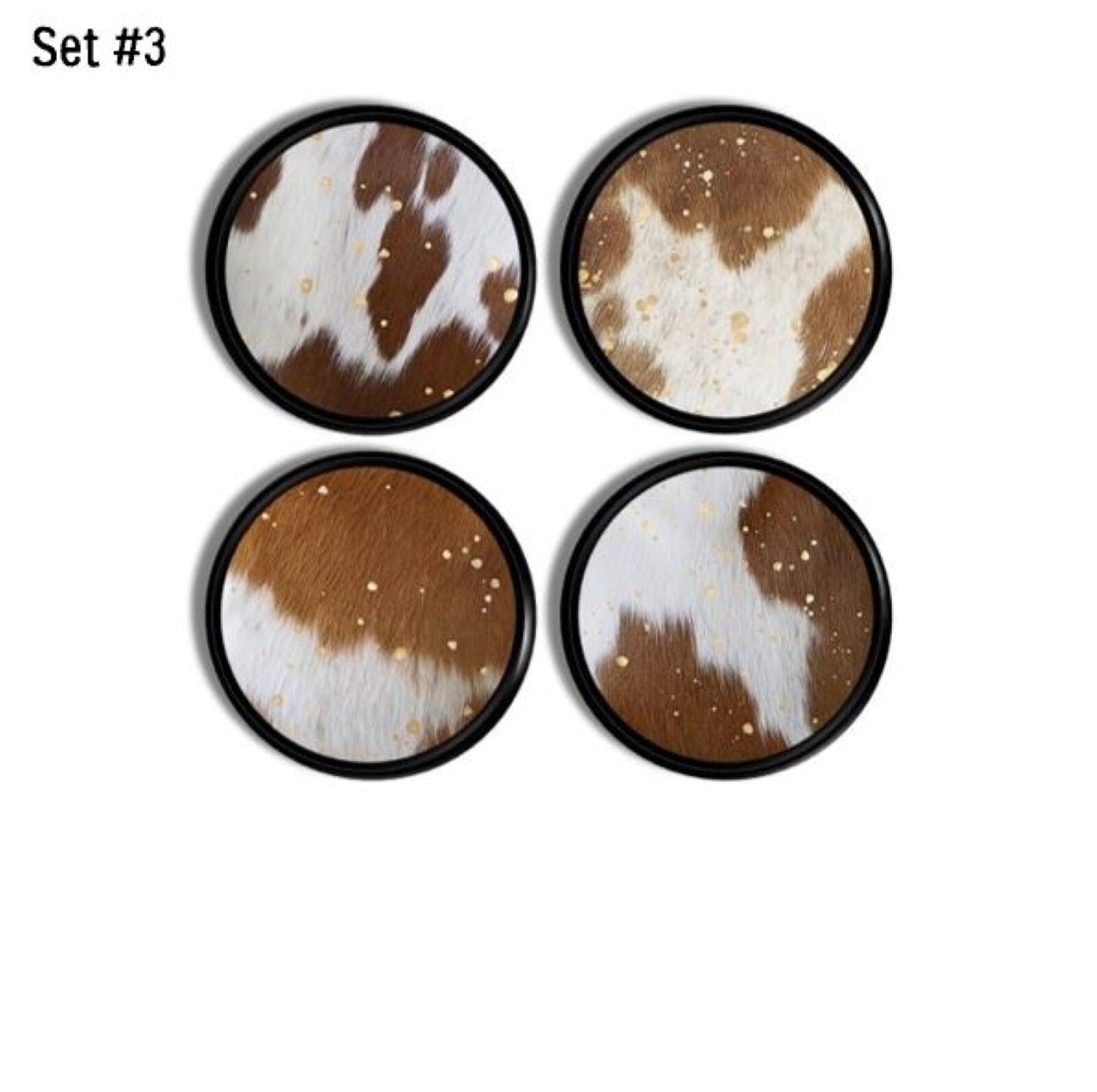 4 decorative cupboard knobs in a cow spot print with subtle gold specks on black base. Southwestern and country western decor.