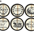 Farmhouse cabinet knobs with vintage dairy farm cow graphics in black ink on cream striped flour sack background. Rustic drawer pulls for country kitchen and pantry décor