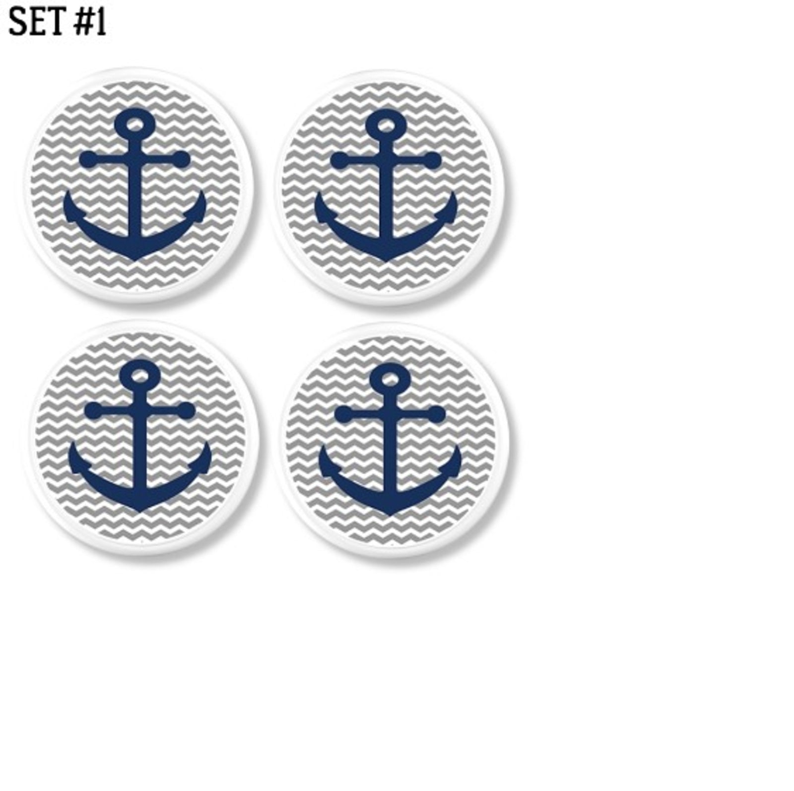 Four coastal cabinet knobs with navy blue anchors on gray and white chevron background. Nautical accent hardware for drawers, vanities, or lake house cottage furniture projects.