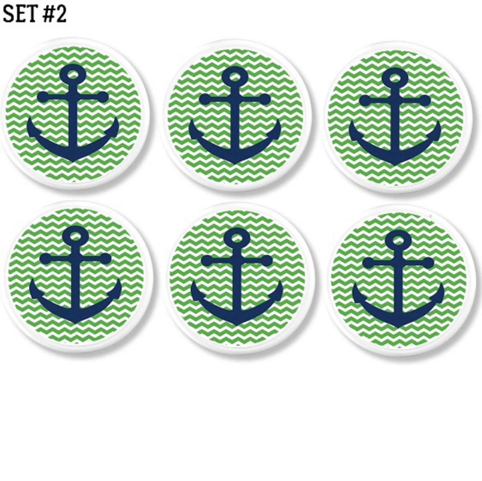Six decorative cabinet knobs with navy blue anchors on green and white chevron zig zag background. Coastal hardware for nautical themed kitchen, bathroom, or kids’ room.