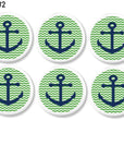 Six decorative cabinet knobs with navy blue anchors on green and white chevron zig zag background. Coastal hardware for nautical themed kitchen, bathroom, or kids’ room.