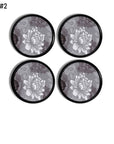 Four round decorative drawer pulls featuring white flower stencil on gray damask. Modern Farmhouse style hardware.