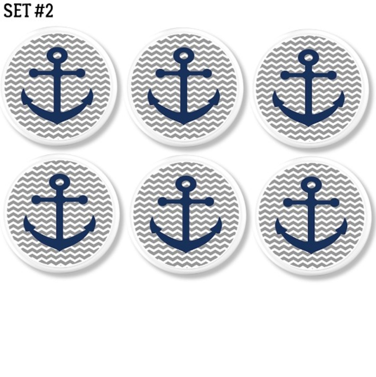 Six handcrafted cabinet knobs featuring navy blue anchors on gray and white chevron background. Nautical drawer pulls for beach house or coastal nursery.