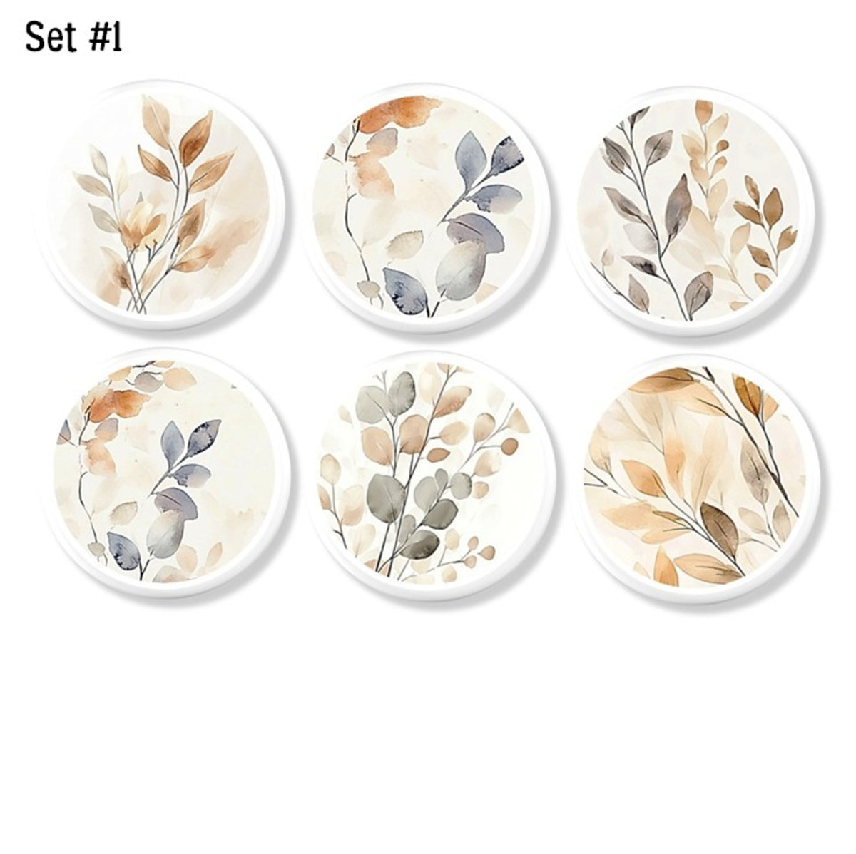 Six-piece neutral botanical cabinet knob  and drawer pull collection featuring soft watercolor leaves in beige, sage, gray, and warm earth tones on white knob bases, ideal for organic modern, Scandinavian, and contemporary furniture makeovers