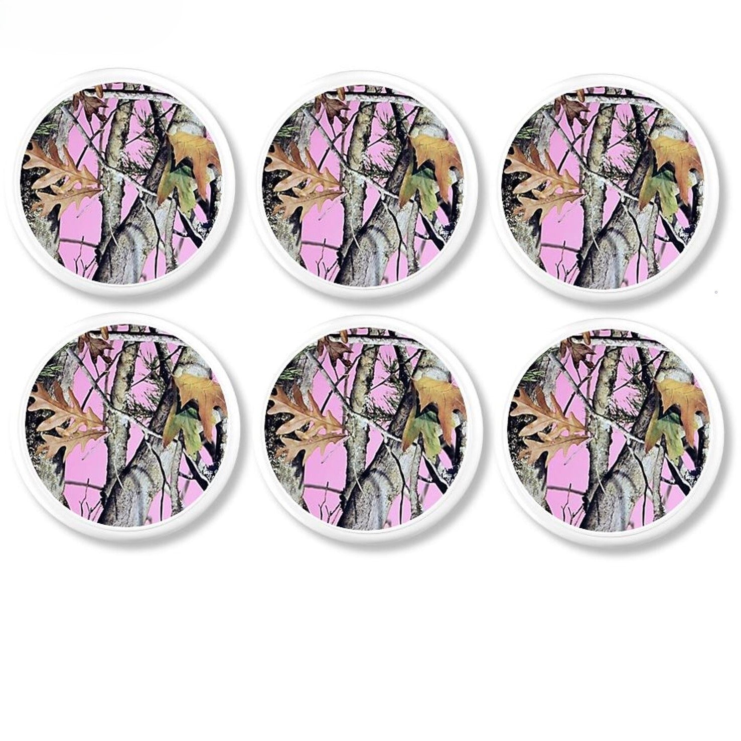 Six white cabinet knobs with vibrant pink camo patterns inspired by outdoor gear, hunting style, and nature‑themed rooms.