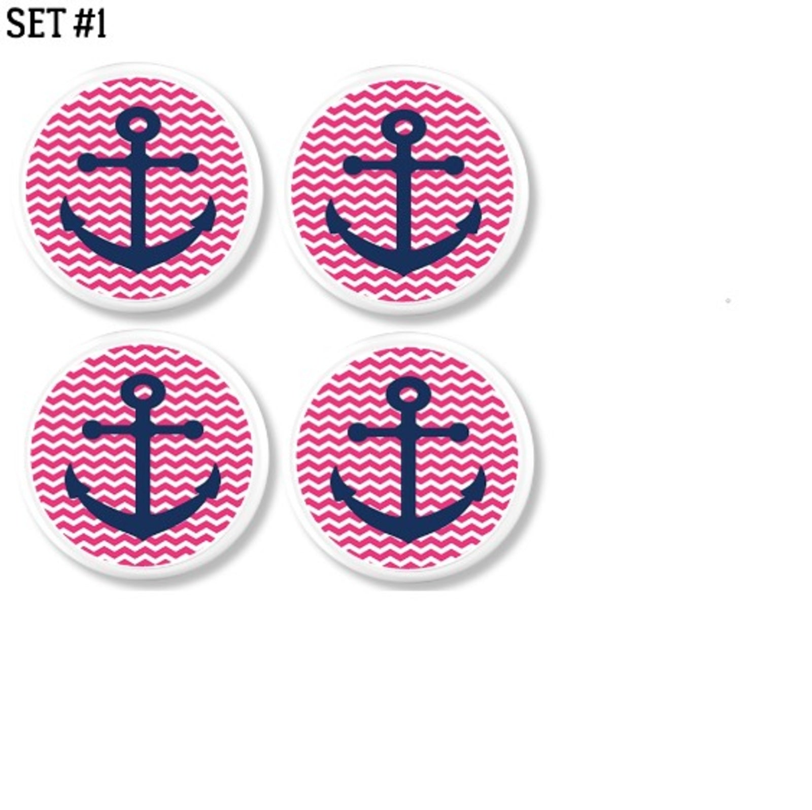 Four handcrafted cabinet knobs with navy blue anchors on pink and white chevron background. Nautical hardware for coastal vanities, themed dressers, or playful accent furniture.