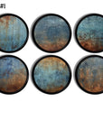 Decorative cabinet knobs in a faux weathered paint texture theme. Rust and navy blue peeling paint look on a black drawer pull. Rustic gruge industral or abstract art decor.