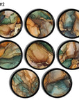 Eight handcrafted cabinet knobs featuring vibrant layered mineral patterns with deep greens, warm rust, canyon‑tone oranges, and fluid agate‑style swirls, creating a bold earthy boho accent for eclectic or nature‑inspired furniture.