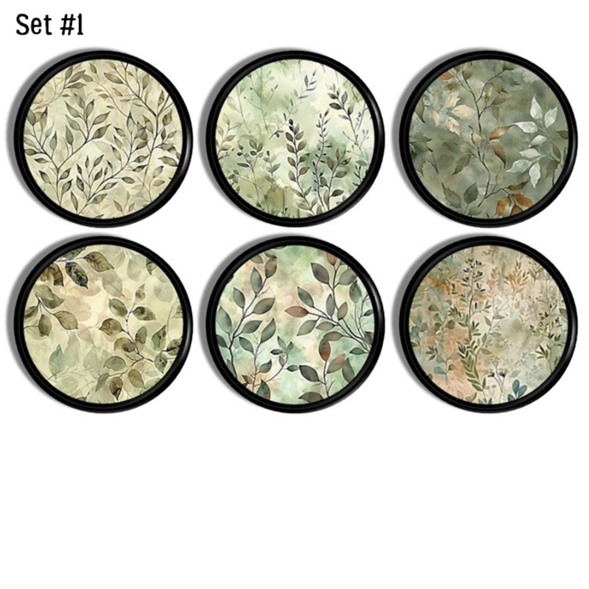 Watercolor leaf cabinet knobs and drawer pull handles with soft sage and beige foliage on a bold black wood base