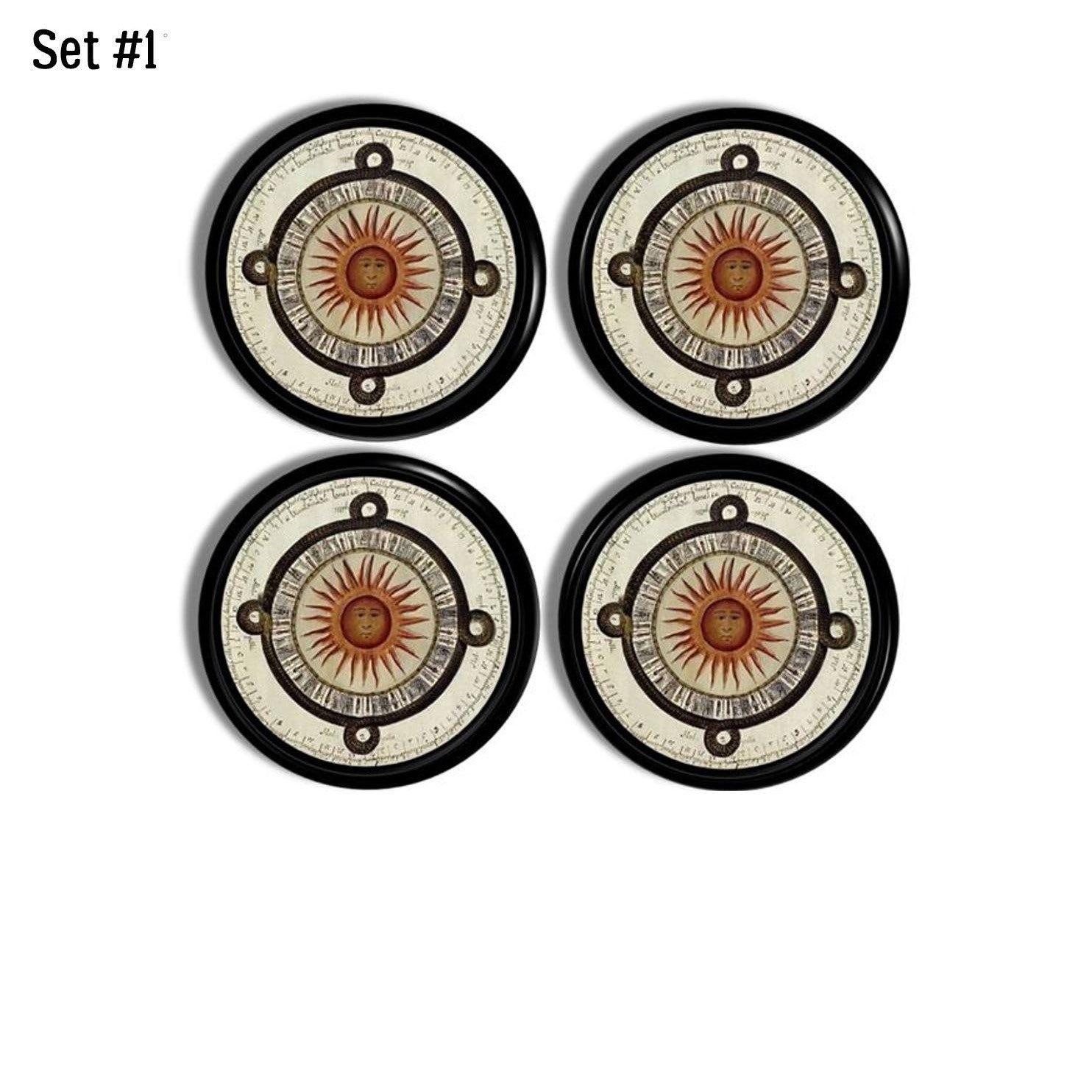 Four black cabinet knobs featuring an Aztec‑inspired sun face with compass rings and tribal script for earthy boho décor.