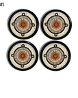 Four black cabinet knobs featuring an Aztec‑inspired sun face with compass rings and tribal script for earthy boho décor.