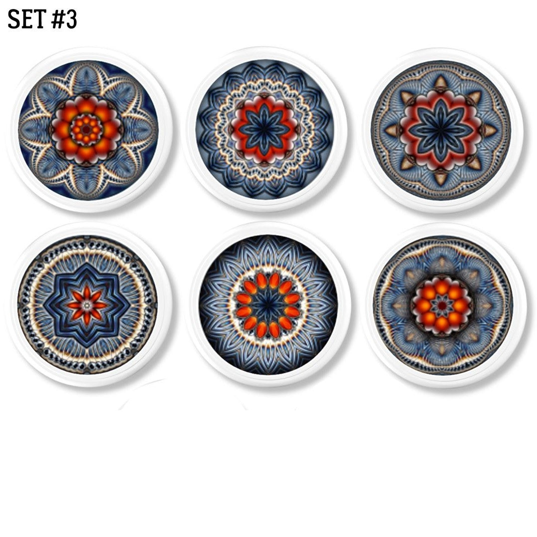 Six handcrafted cabinet knobs featuring quilt-inspired mandala designs in vibrant blue, red, and orange tones — each with a unique symmetrical pattern and artisan flair. Perfect for expressive drawer pulls in Boho, Indie, or Cottagecore interiors.
