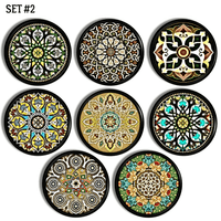 Handmade cabinet drawer pull set decorated with colorful bohemian floral mandala art on a black knob.