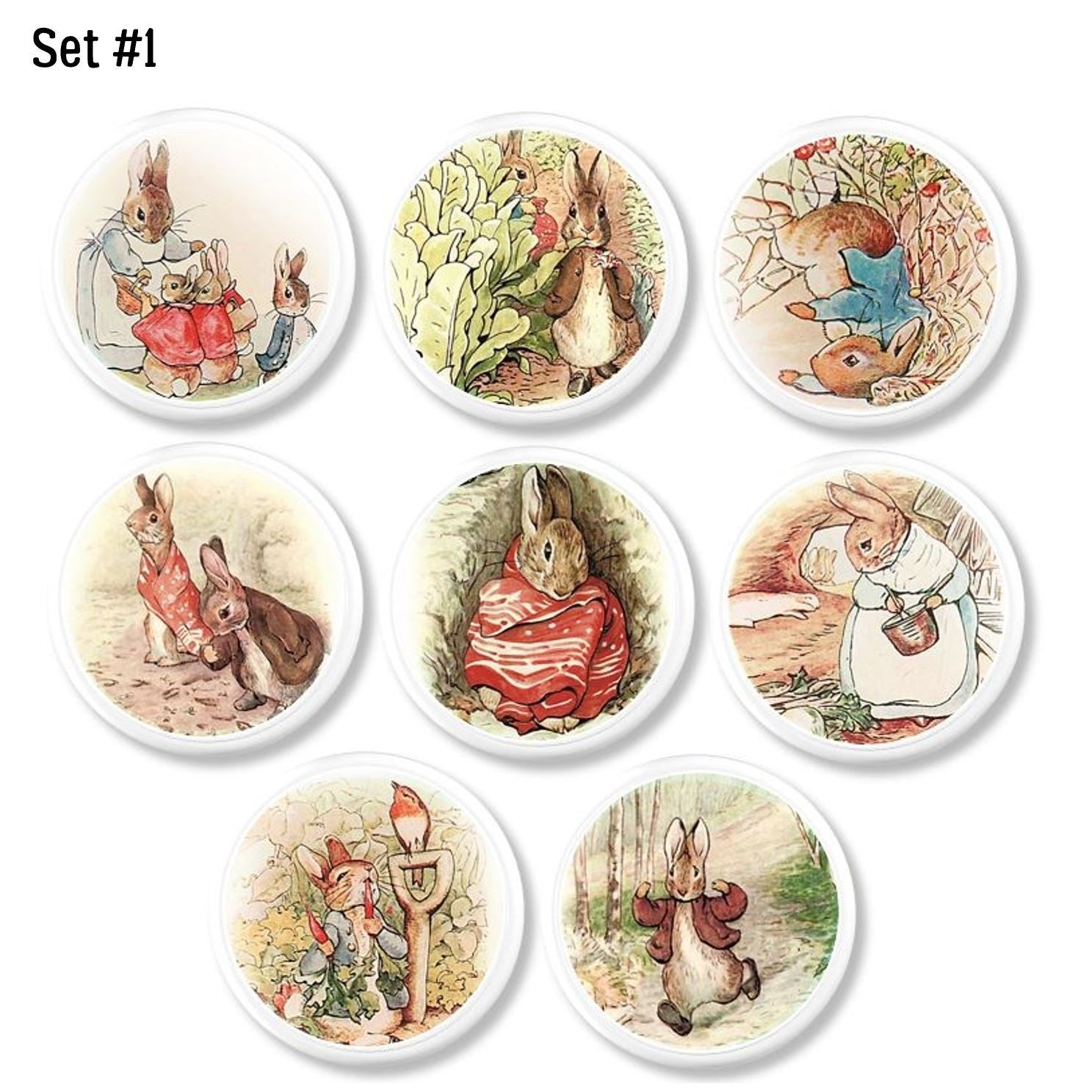 Eight handcrafted cabinet knobs featuring classic Peter Rabbit garden scenes in soft pastel watercolor style, perfect for nurseries, playrooms, and storybook décor.