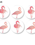 6 Pink flamingo art decorative cabinet knobs. in various hues of salmon and coral on a white drawer pull for a subtle tropical accent.