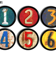 Decorative cabinet and furniture knobs in rusty old license plate numbers on colorful red, green, blue and yellow.