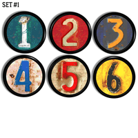 Decorative cabinet and furniture knobs in rusty old license plate numbers on colorful red, green, blue and yellow.