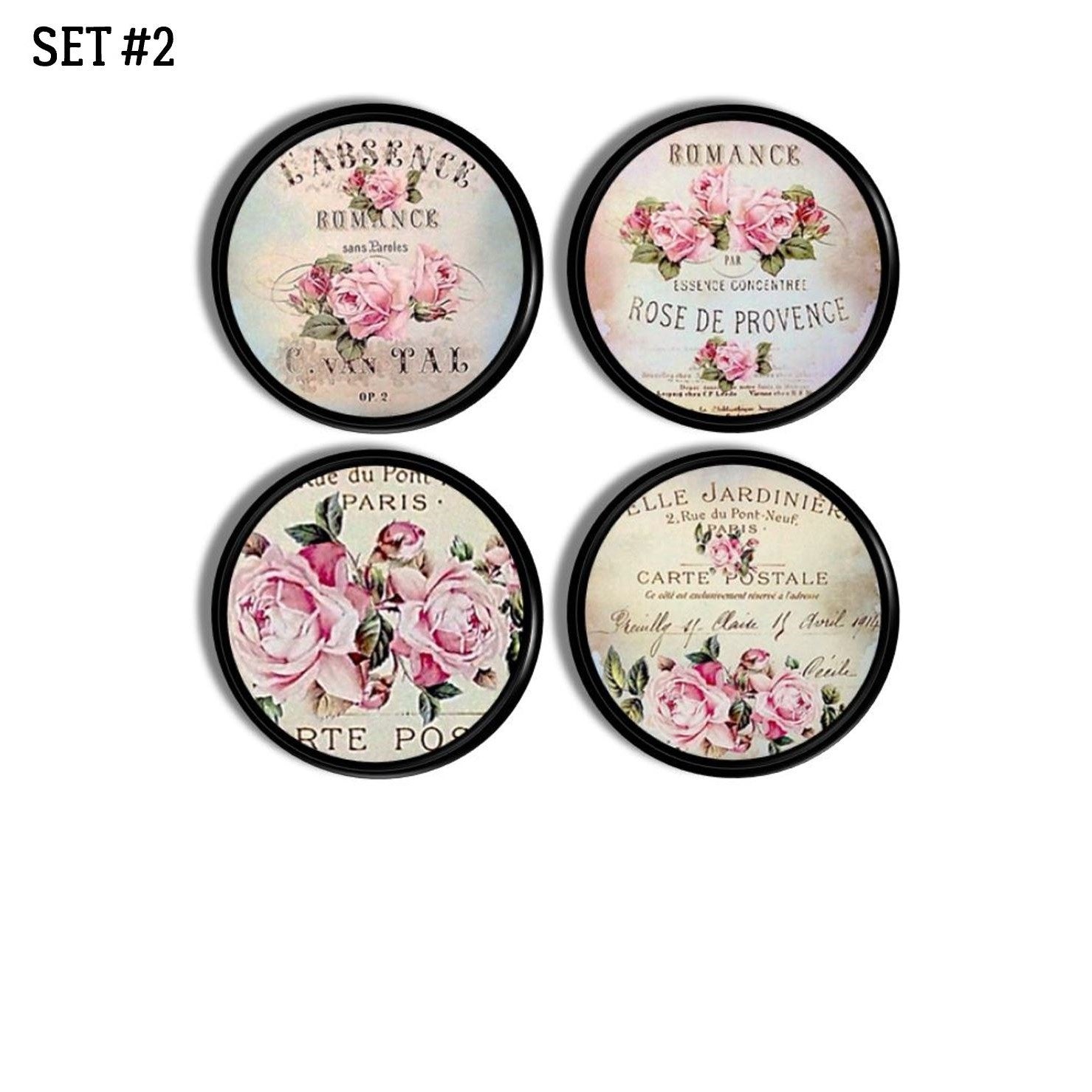 Antique style cabinet knob set with French floral label art — dusty pink roses and vintage script on deep black knobs.