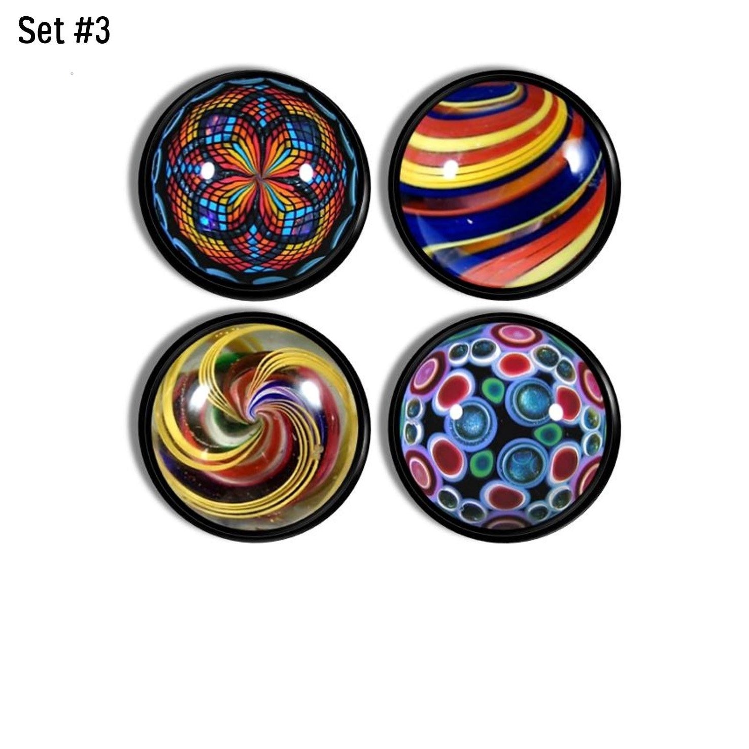 Four handcrafted cabinet drawer pulls featuring simulated vintage glass marbles on a black base knob, with ribbon swirls, spirals, concentric circles, and kaleidoscope motifs in bright retro colors.